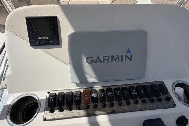 Slide: The Image of 2021 Carolina Skiff 24 Ultra Elite dashboard with Garmin and Suzuki displays. - 14