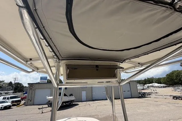 Slide: The Image of 2021 Carolina Skiff 24 Ultra Elite boat with T-top and storage compartment. - 13