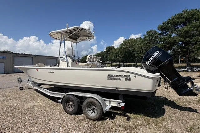 The Image of 2021 Carolina Skiff 24 Ultra Elite boat on trailer with Suzuki outboard motor. - 0