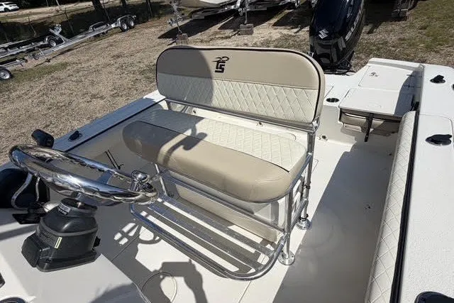 Slide: The Image of 2021 Carolina Skiff 24 Ultra Elite boat interior with beige seating and steering console. - 15