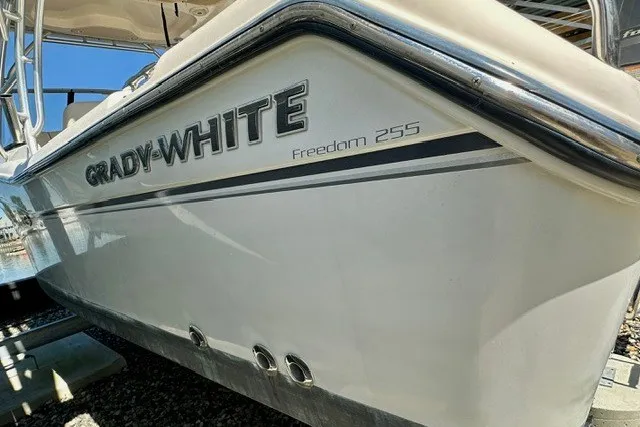 Slide: The Image of 2015 Grady-White Freedom 255 boat side view with logo and model name. - 11