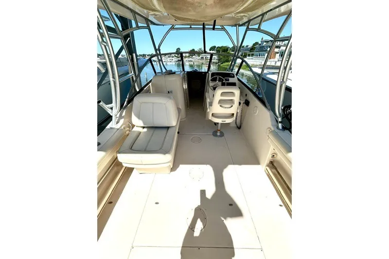 Slide: The Image of 2015 Grady-White Freedom 255 boat interior with seating and steering console. - 9