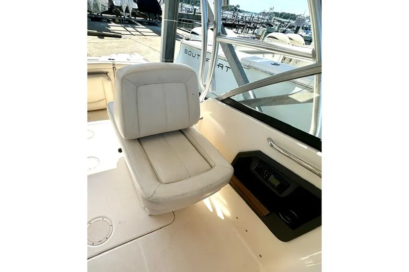 Slide: The Image of 2015 Grady-White Freedom 255 boat interior with cushioned seating and control panel. - 8