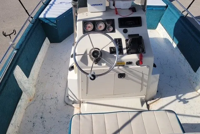 Slide: The Image of 1999 ProMaster 220 Bay boat interior with steering wheel and control panel. - 1