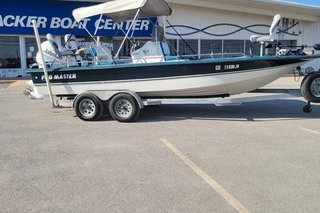 Slide: The Image of 1999 ProMaster 220 Bay boat on trailer outside Tracker Boat Center. - 4