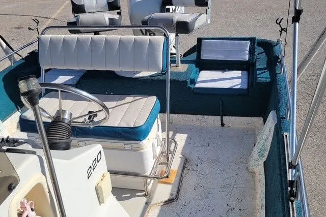 Slide: The Image of 1999 ProMaster 220 Bay boat interior with blue and white seating and steering wheel. - 5