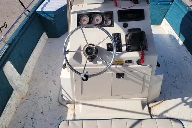 Slide: The Image of 1999 ProMaster 220 Bay boat cockpit with steering wheel and control panel. - 8