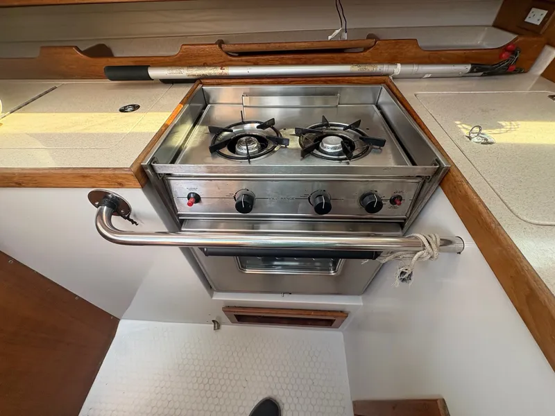 Slide: The Image of The galley of a 1997 Catalina 36 with a two-burner stove and oven. - 25