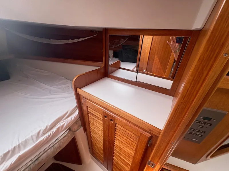 Slide: The Image of Interior of a 1997 Catalina 36 with wooden cabinets and a bed. - 30