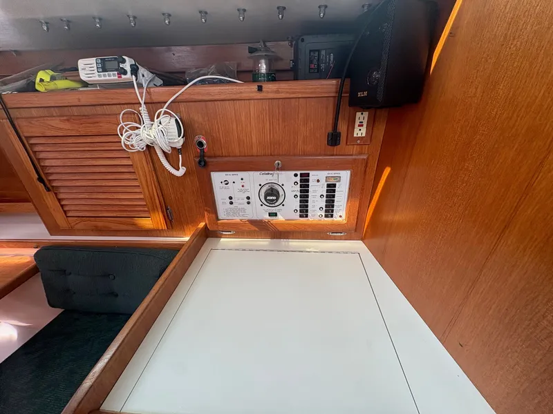 Slide: The Image of Interior of a 1997 Catalina 36 with wooden walls and a control panel. - 16