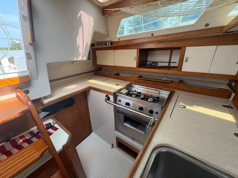 Slide: The Image of Interior of a 1997 Catalina 36 featuring a kitchen with stove and sink. - 21