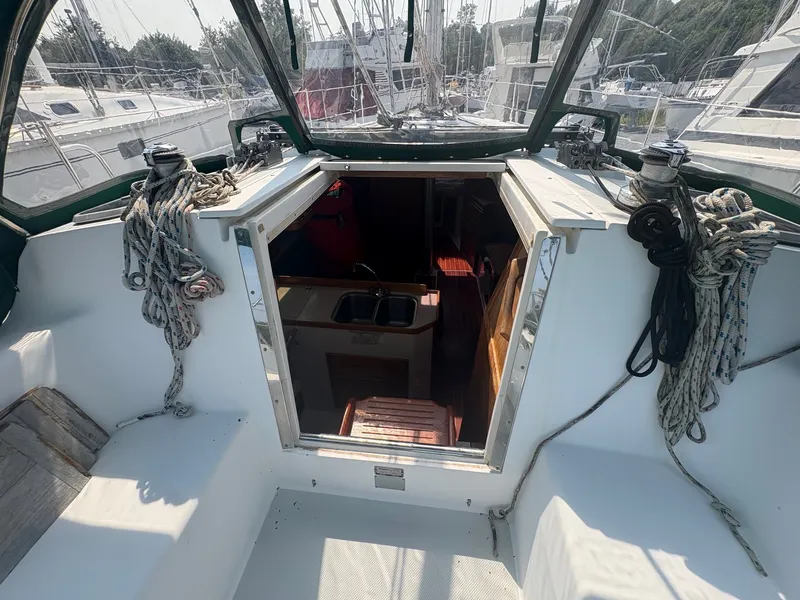 Slide: The Image of The image shows the cockpit of a 1997 Catalina 36, with a view into the interior. - 14