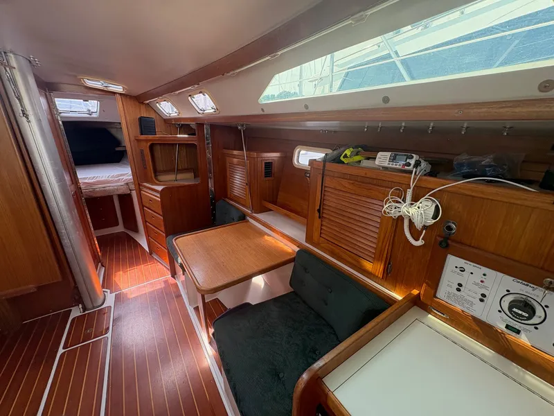 Slide: The Image of Interior of a 1997 Catalina 36 with wooden furnishings and a seating area. - 17
