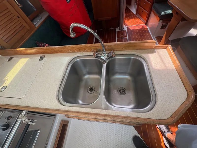 Slide: The Image of Galley of the 1997 Catalina 36 with a double sink and wooden countertop. - 22