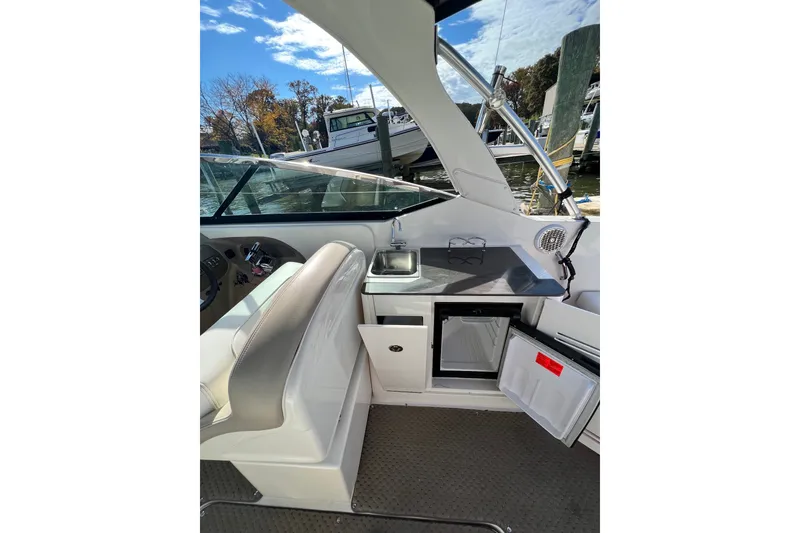 Slide: The Image of Interior view of 2013 Sea Ray 300 SLX boat with kitchenette and seating. - 6