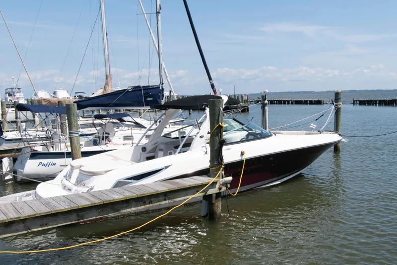 The Image of 2013 Sea Ray 300 SLX boat docked at a marina on a sunny day. - 0