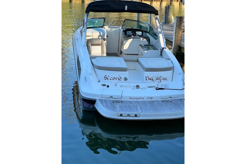 Slide: The Image of 2013 Sea Ray 300 SLX boat docked, featuring spacious seating and sleek design. - 2