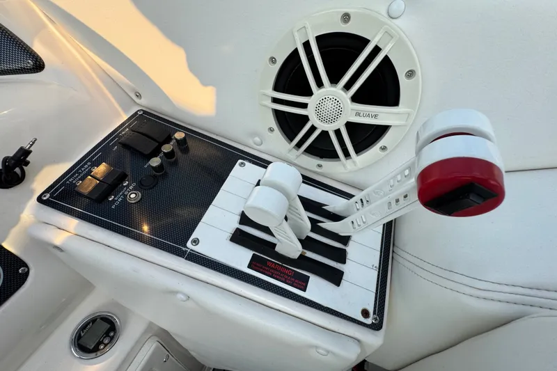 Slide: The Image of Control panel of a 2008 Envision 3600 Legacy ESP boat with speaker and throttle levers. - 15