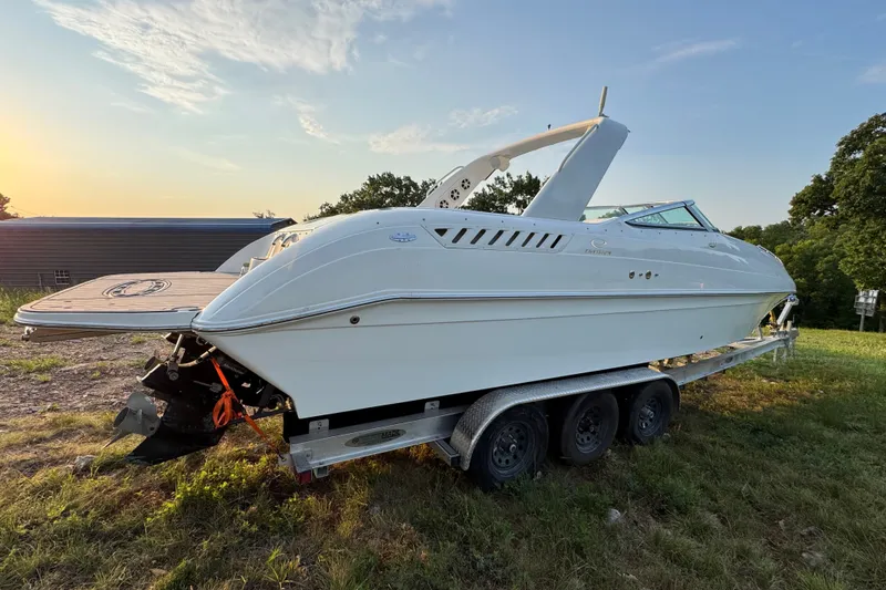 Slide: The Image of 2008 Envision 3600 Legacy ESP boat on trailer, parked outdoors at sunset. - 5