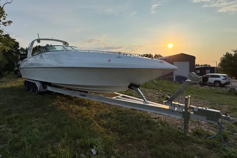 Slide: The Image of 2008 Envision 3600 Legacy ESP boat on trailer at sunset, parked outdoors. - 4
