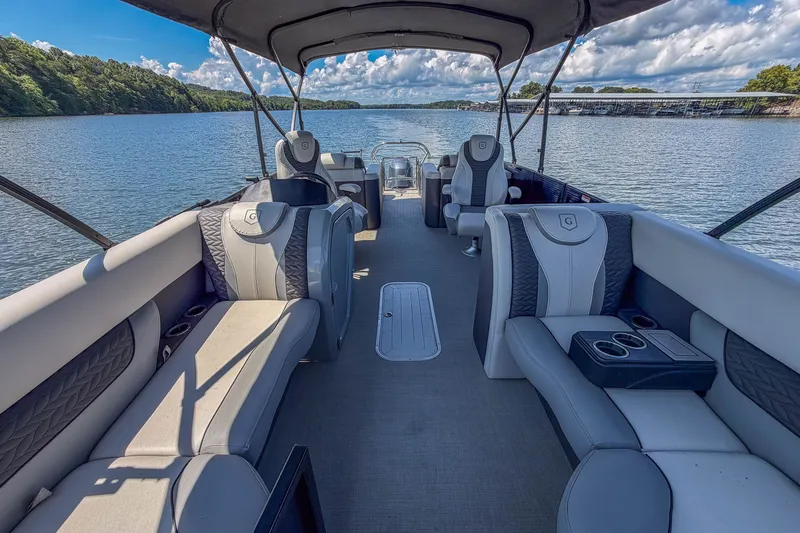 Slide: The Image of 2021 Godfrey Monaco 235 pontoon boat interior on a scenic lake. - 30