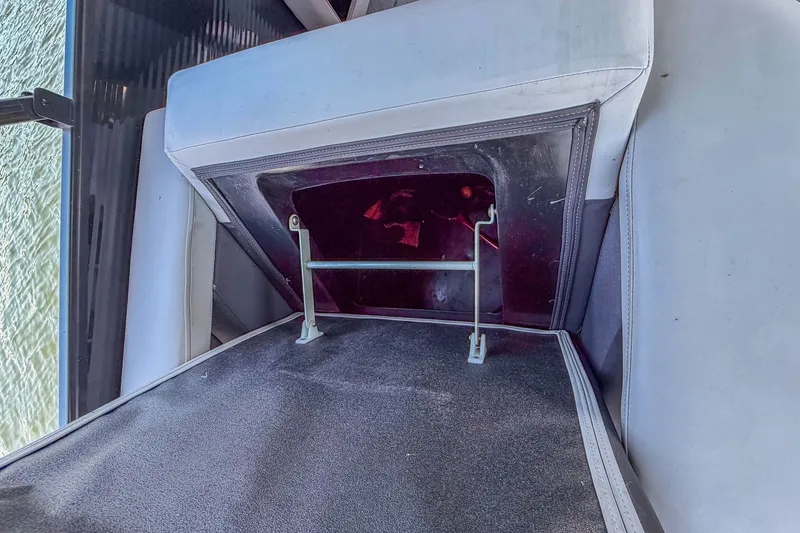 Slide: The Image of Interior view of a 2021 Godfrey Monaco 235 boat seat storage compartment. - 23