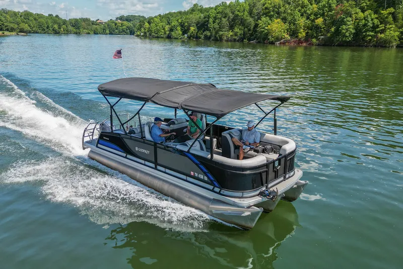 Slide: The Image of 2021 Godfrey Monaco 235 pontoon boat cruising on a scenic lake. - 18