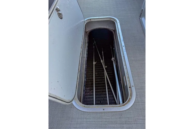 Slide: The Image of Open storage compartment on 2021 Godfrey Monaco 235 boat, revealing interior space. - 41