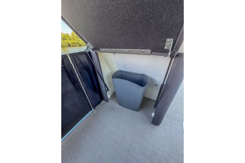 Slide: The Image of Interior of 2021 Godfrey Monaco 235 boat with a gray trash bin. - 22
