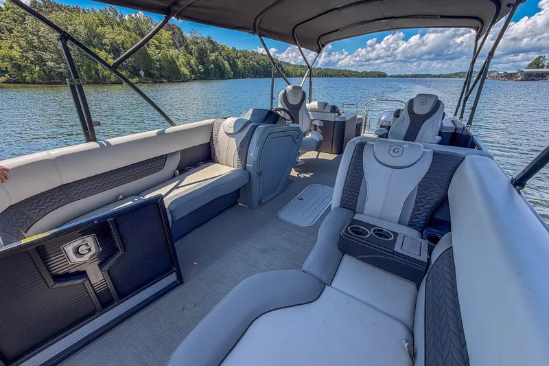 Slide: The Image of Luxurious 2021 Godfrey Monaco 235 pontoon boat interior on a scenic lake. - 32