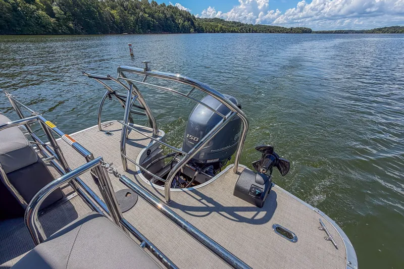 Slide: The Image of 2021 Godfrey Monaco 235 pontoon boat on a scenic lake with clear skies. - 25