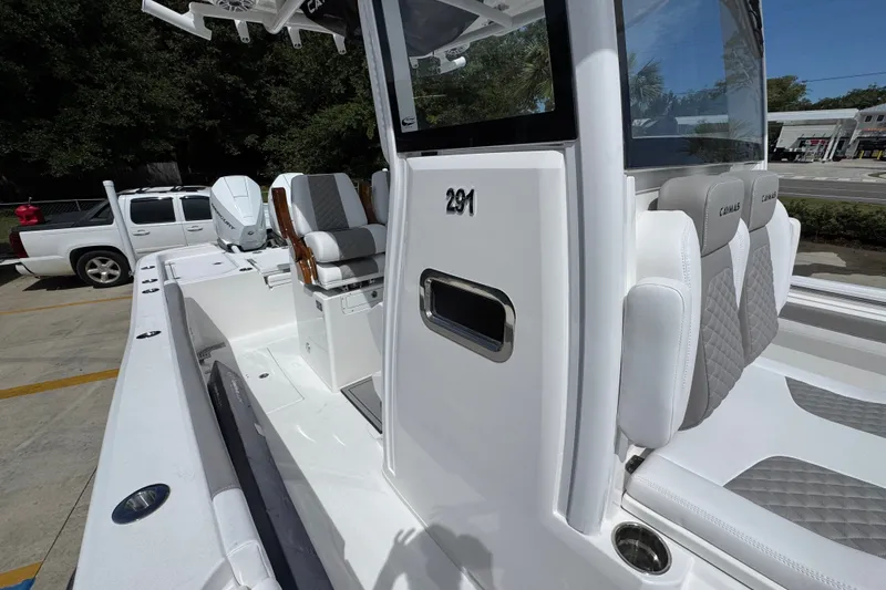 Slide: The Image of 2027 Caymas 291 boat interior with sleek seating and modern design features. - 26