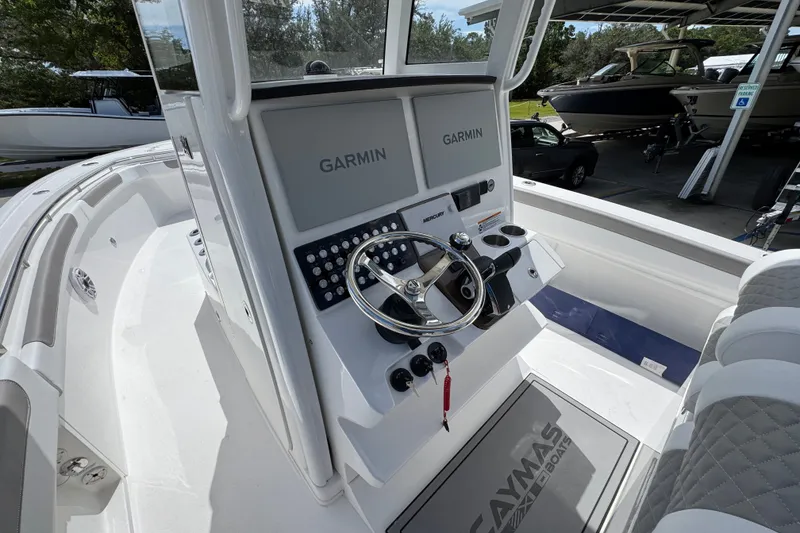 Slide: The Image of 2027 Caymas 291 boat cockpit with Garmin navigation system and steering wheel. - 32