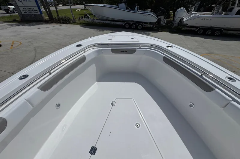 Slide: The Image of 2027 Caymas 291 boat deck, spacious and sleek design, parked at a marina. - 20