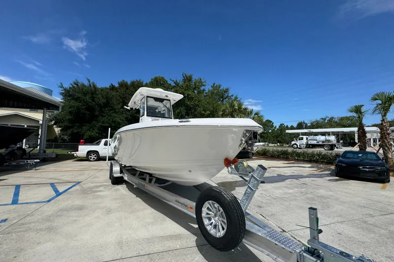 Slide: The Image of 2027 Caymas 291 boat on trailer in sunny outdoor setting. - 7