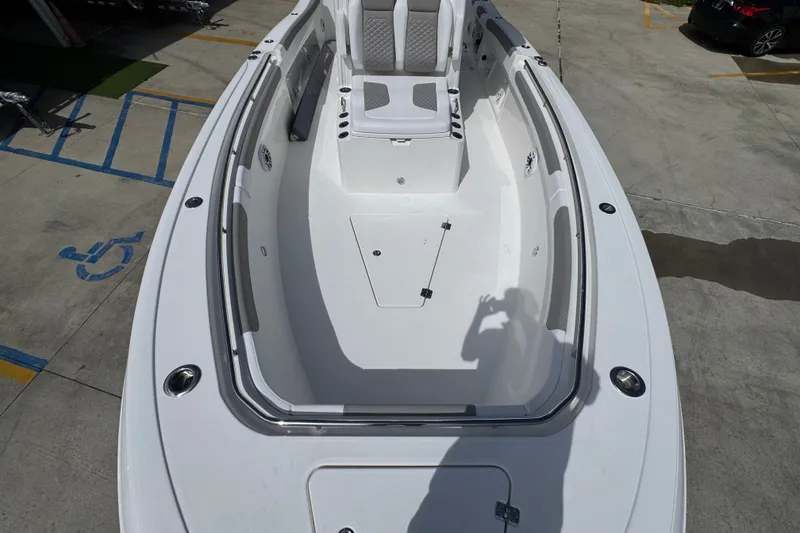 Slide: The Image of 2027 Caymas 291 boat interior, spacious seating, sleek design, photographed in a parking area. - 22