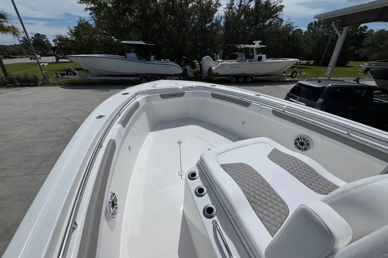Slide: The Image of 2027 Caymas 291 boat interior with cushioned seating and sleek design. - 21