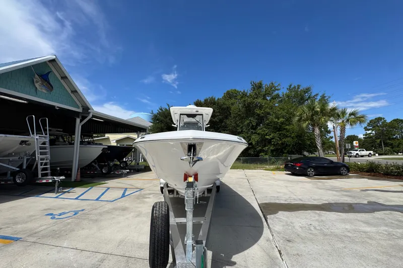 Slide: The Image of 2027 Caymas 291 boat on trailer in sunny outdoor setting. - 6