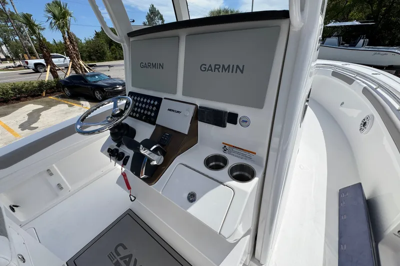 Slide: The Image of 2027 Caymas 291 boat helm with Garmin displays and Mercury controls. - 36