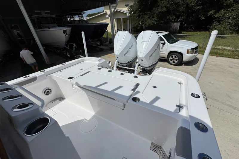 Slide: The Image of 2027 Caymas 291 boat with dual Mercury engines in a driveway setting. - 39