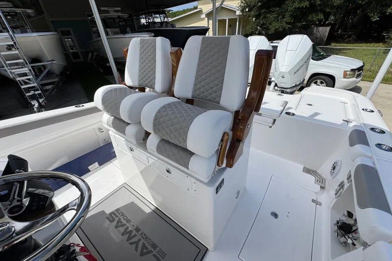 Slide: The Image of Luxury seating on 2027 Caymas 291 boat with dual Mercury engines in a showroom. - 28