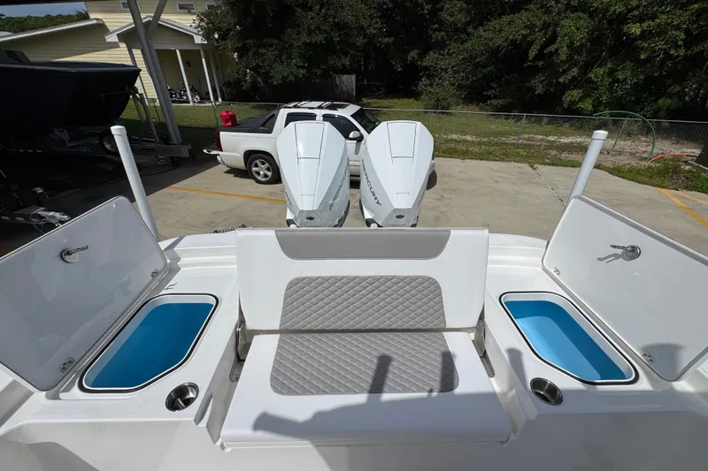 Slide: The Image of 2027 Caymas 291 boat with dual outboard engines and open storage compartments. - 41