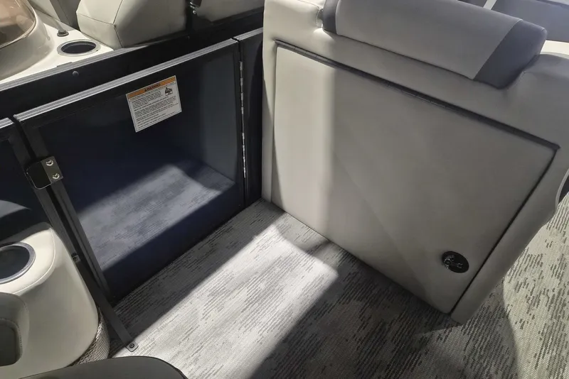 Slide: The Image of Interior of 2026 Sylvan X3 DLZ DH BAR boat, featuring seating and storage area. - 7