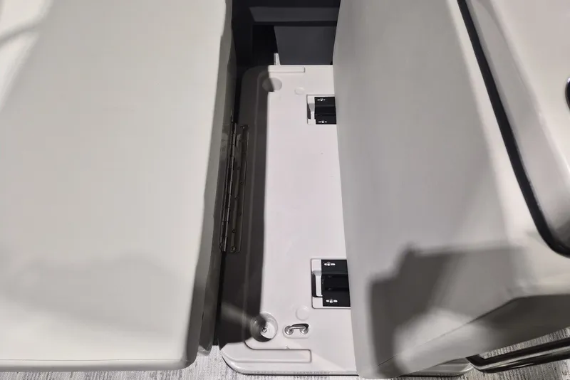 Slide: The Image of Interior view of 2026 Sylvan X3 DLZ DH BAR boat seating area with storage compartment. - 16