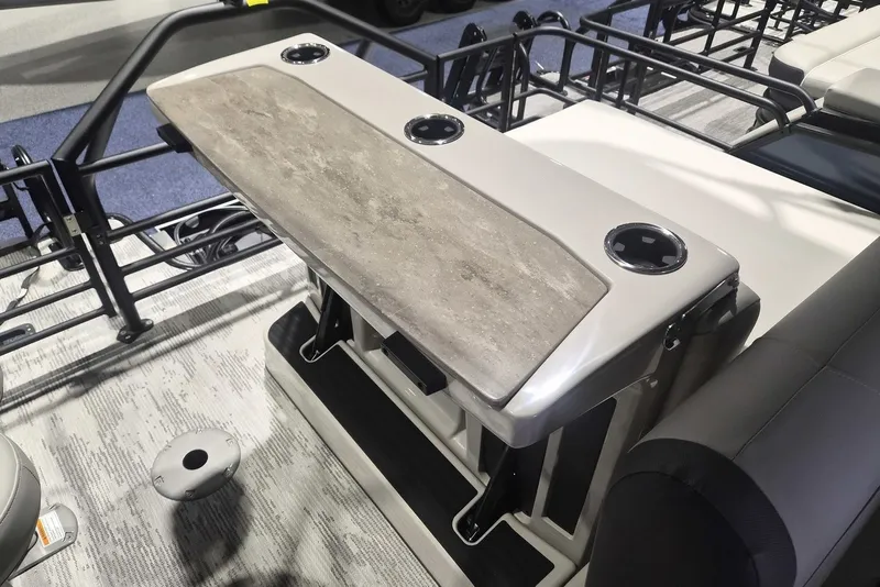 Slide: The Image of 2026 Sylvan X3 DLZ DH BAR boat interior with sleek table and cup holders. - 14
