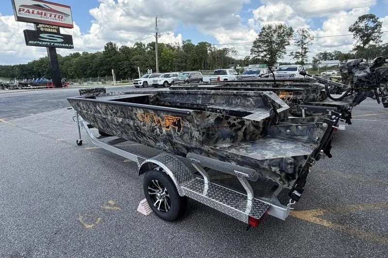 Slide: The Image of 2027 Excel 1751 Viper F4 boat on trailer in dealership lot, camo design. - 1