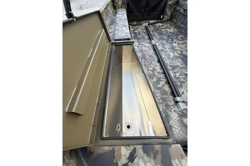 Slide: The Image of Interior view of 2027 Excel 1751 Viper F4 boat with camo design and storage compartment. - 10