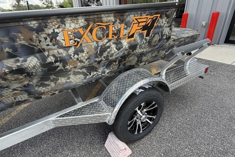 Slide: The Image of 2027 Excel 1751 Viper F4 boat with camouflage design on a trailer. - 9