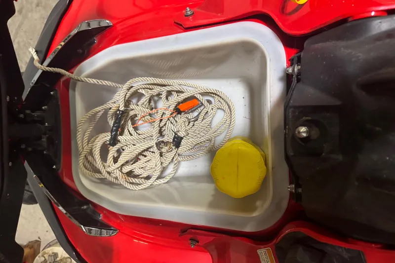Slide: The Image of Storage compartment of a 2007 Kawasaki Jet Ski Ultra 250X with rope and yellow cap. - 12