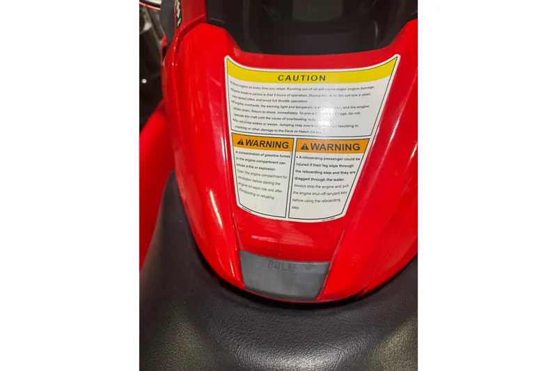 Slide: The Image of 2007 Kawasaki Jet Ski Ultra 250X with caution and warning labels on red body. - 10